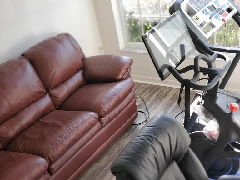 sofabed spin bike andtreadmill provided in office