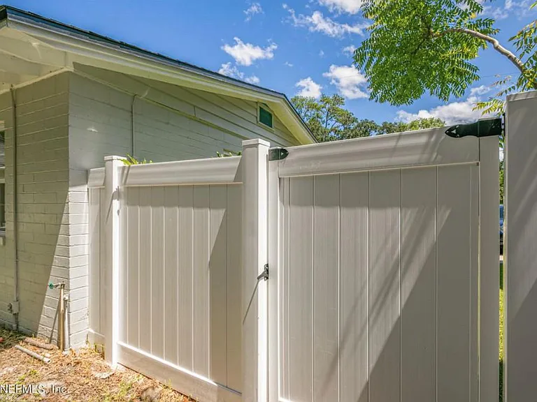 Fenced back yard with storage shed.