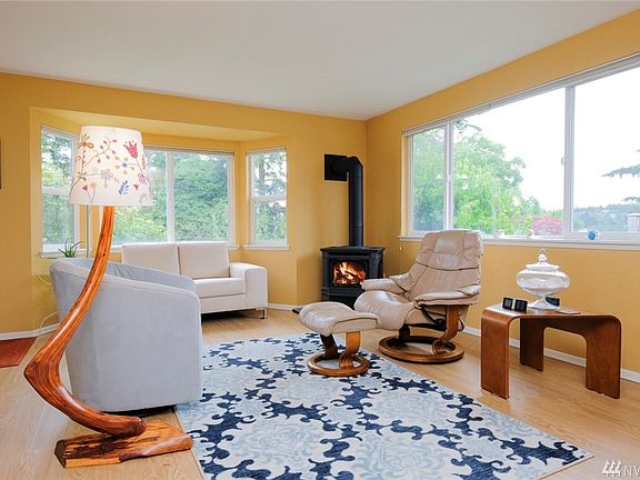 The living room has big windows on both sides to let in light and nice mountain view in the wintertime.  A brand new propane fireplace anchors the room with warmth and character.  