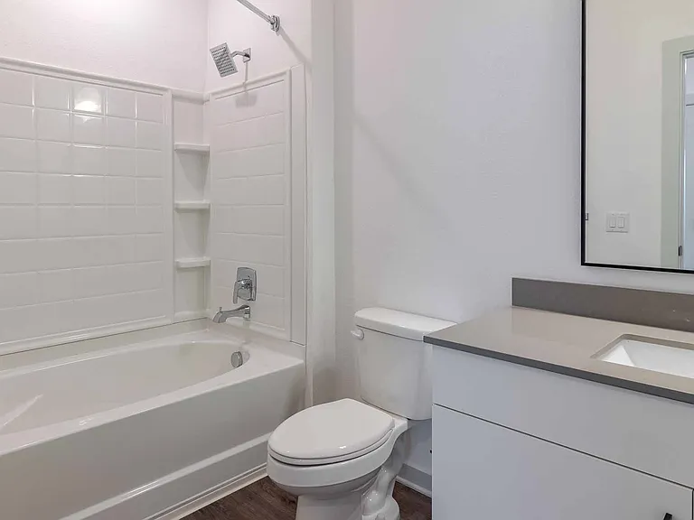 Second full bathroom with a tub and shower combo, tile surround, and a quartz-topped vanity. Second full bathroom with a tub and shower combo, tile surround, and a quartz-topped vanity.