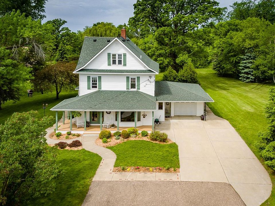 This beautiful home invites you in with beautiful landscaping and a welcoming front porch.