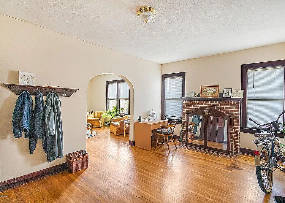 Welcome Home! This is your foyer with laundry closet, original 1935 hardwood floors, fireplace and access to the rest of the apartment.