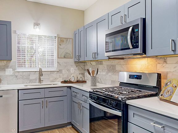Kitchen with Stainless Steel Appliances and Quartz Countertops