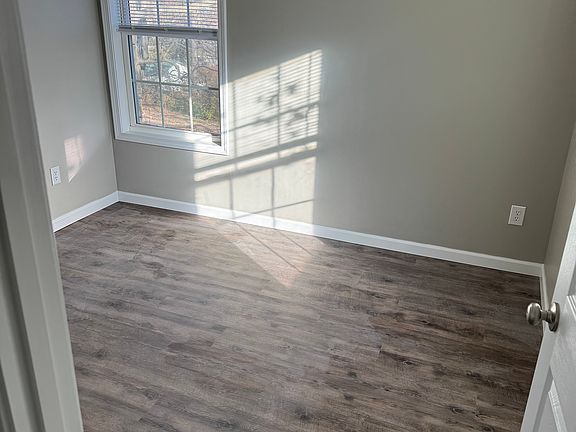 Bedroom with fresh paint, new doors and flooring.