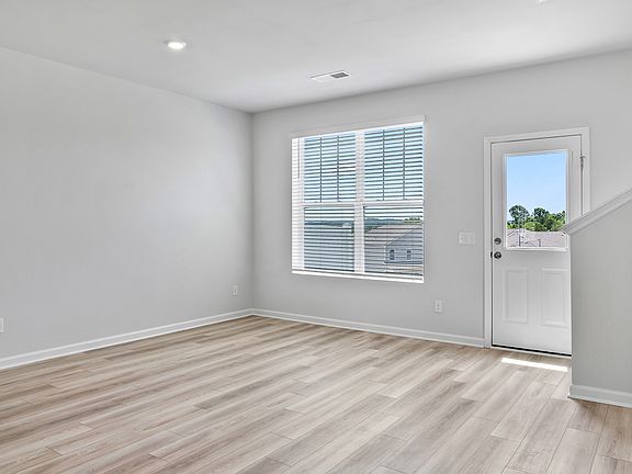 Living room with the backdoor leading to the backyard patio space