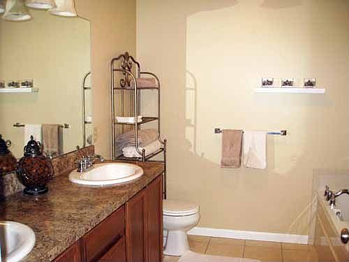 Master bath w/ tile floor, two sinks, stand up shower and soaking tub