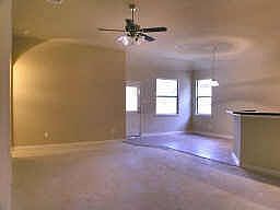 High ceilings.. rounded corners and a ceiling fan.. a great combination room..