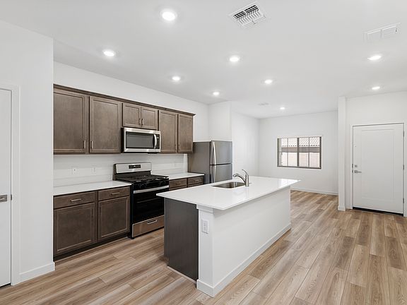 The spacious kitchen seamlessly connects to a separate dining area.