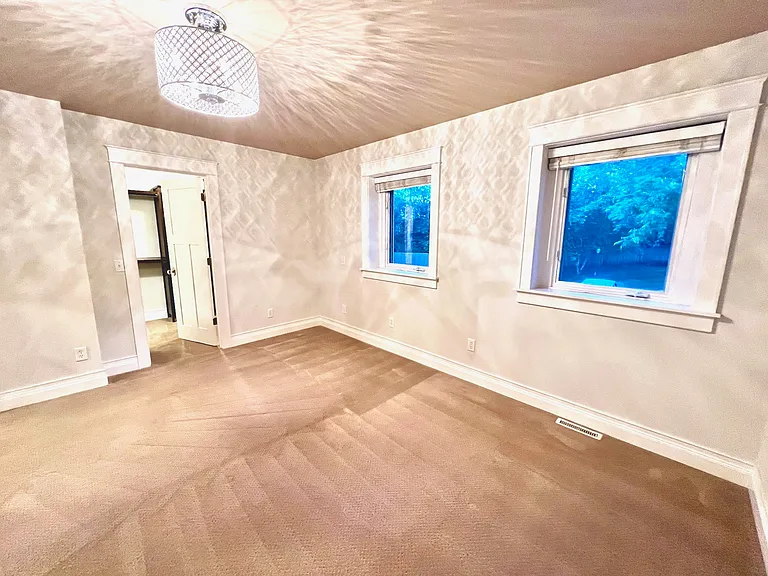 Upper level features a main bedroom suite with spacious walk-in closet, custom built-ins