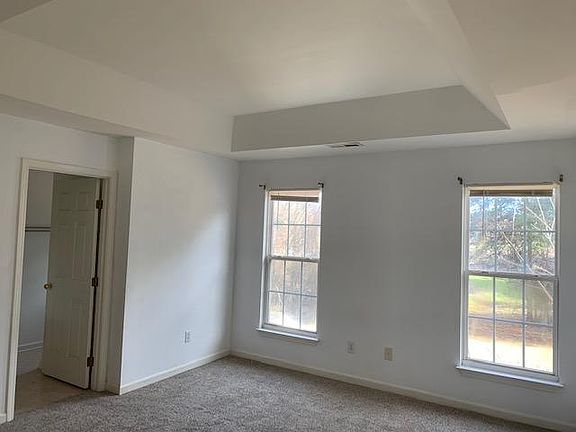 Master bedroom with walk in closet, bathroom and vaulted ceiling