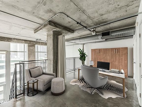 The upstairs Study/Loft area is a great place to work at home> It is separate from LR/DR areas and Bedrooms. Natural light fills the space and the expansive views allow you to not feel boxed in! Queen size murphy bed on far wall is included, creating