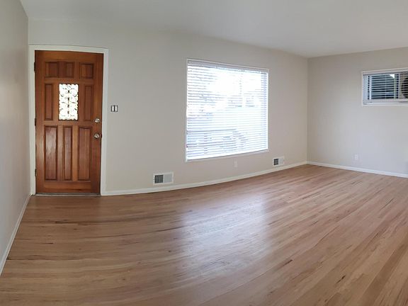 Large Living Room with gorgeous bay window and swamp cooler