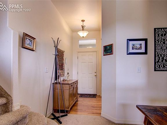 Front entry. Hardwood, window over the door for extra lighting.
