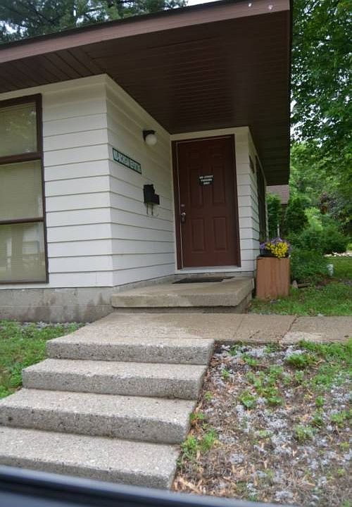 The front entrance has a sidewalk from the street and a walk way from the driveway.