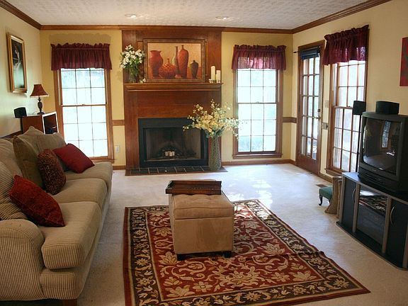 fireside family room with door to deck
