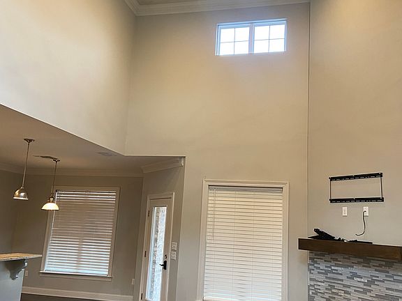 Massive ceilings, wood burning fireplace, exit to rear yard