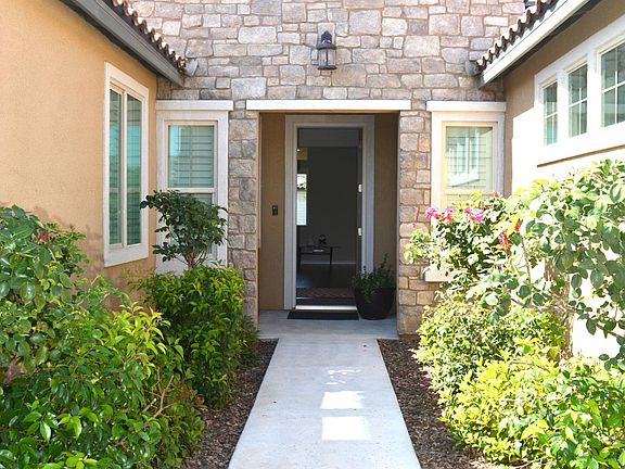 The courtyard has 4 Rose trees leading to the main entrance door.