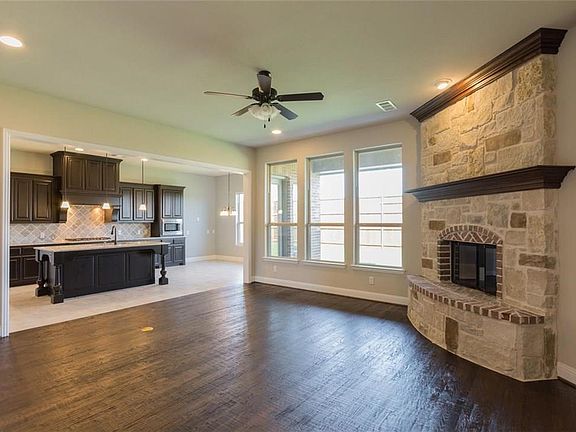 Stone and wood burning fire place. Nailed down hard wood floor.