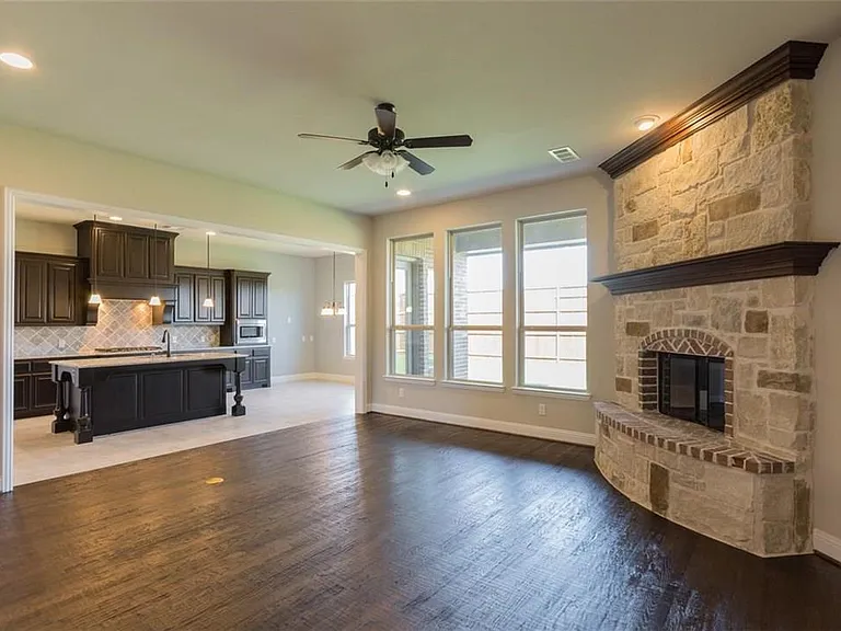 Stone and wood burning fire place. Nailed down hard wood floor.