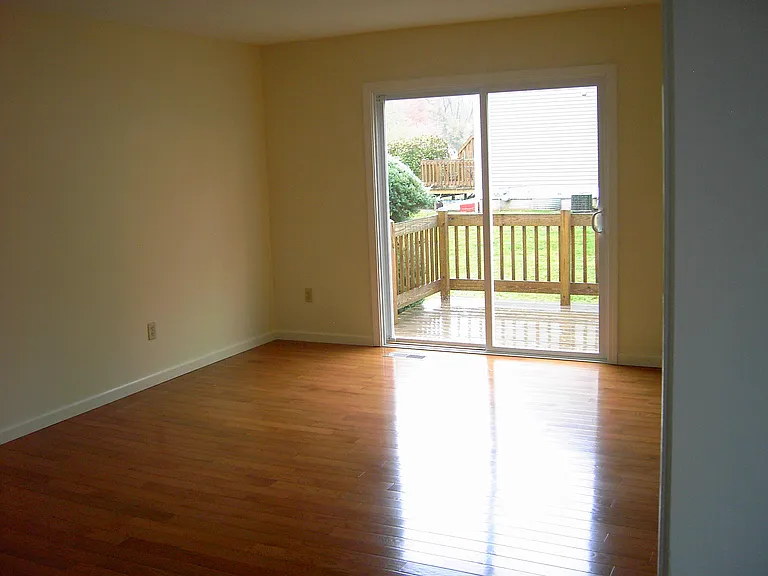 Living Room w/hardwood floors & slider to deck.