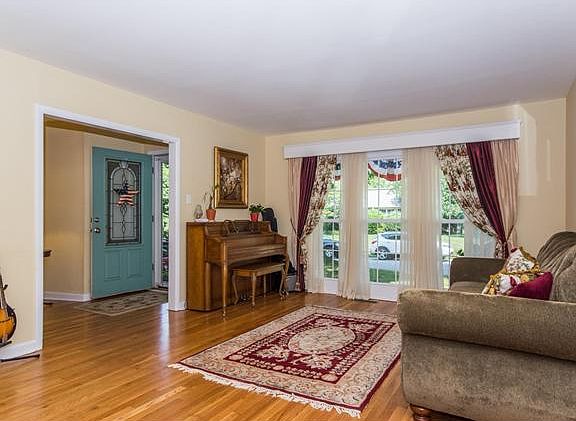 LR with beautiful hardwood floors & tall windows