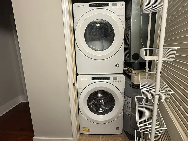 Stackable Washer / Dryer located in laundry closet