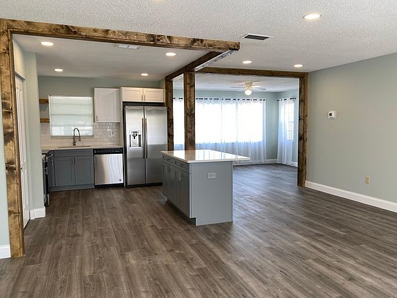 Large open floor plan featuring the living room, kitchen, breakfast bar, and family room.