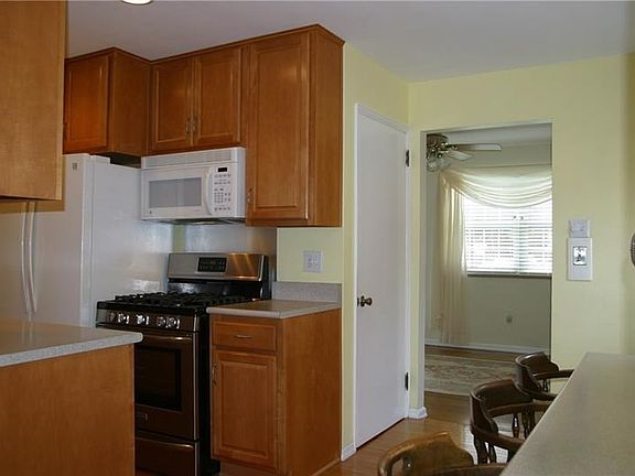 The fully equipped kitchen has been completely remodeled... warm wood tones of the cabinetry compliments the updated appliances 