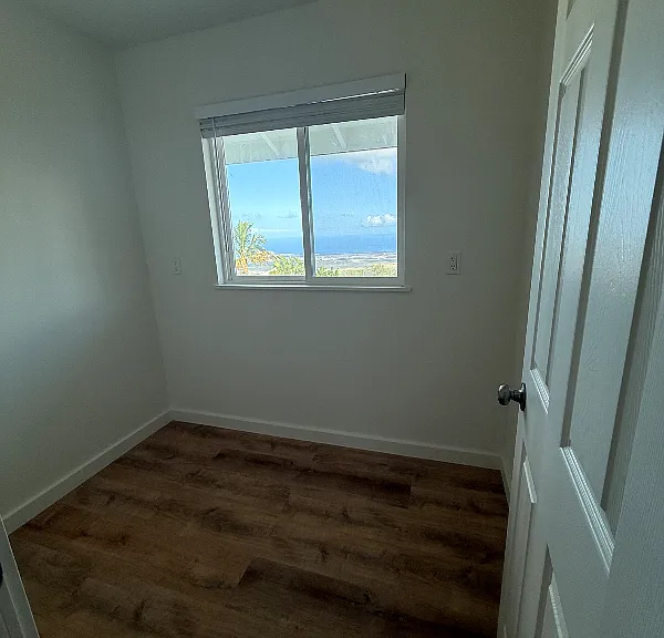 Office with a window off the side of the living room