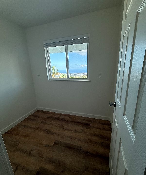 Office with a window off the side of the living room