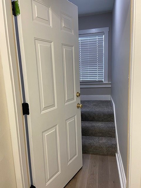 entrance on second floor, three steps to landing turn, wo windows.