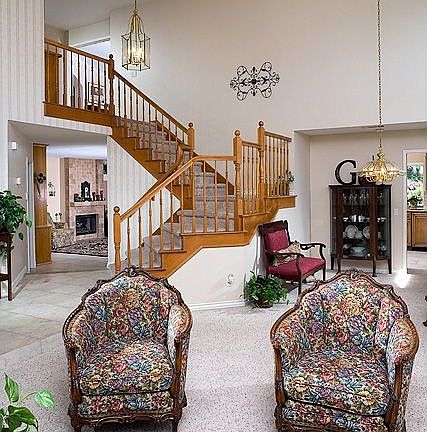 Elegant entry with sweeping staircase and vaulted ceilings