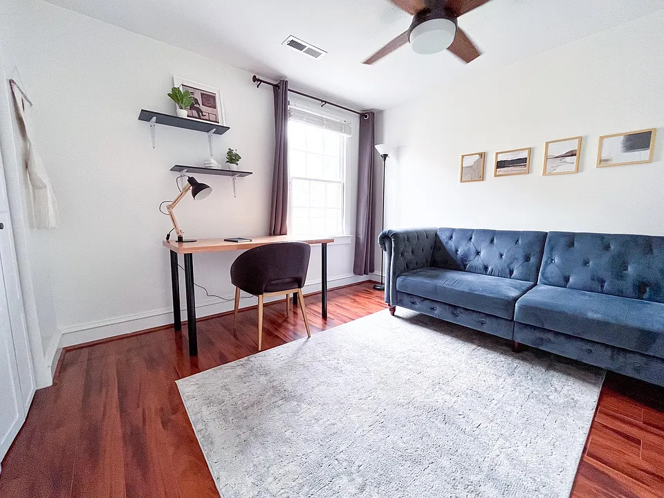 Dedicated home office setup with workspace and convertible sleeper sofa.