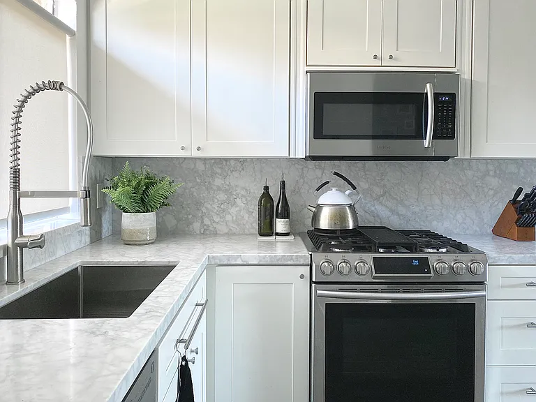 Updated kitchen with marble countertops