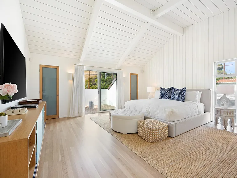 The high ceilings are lined with beautiful white wooden panels.