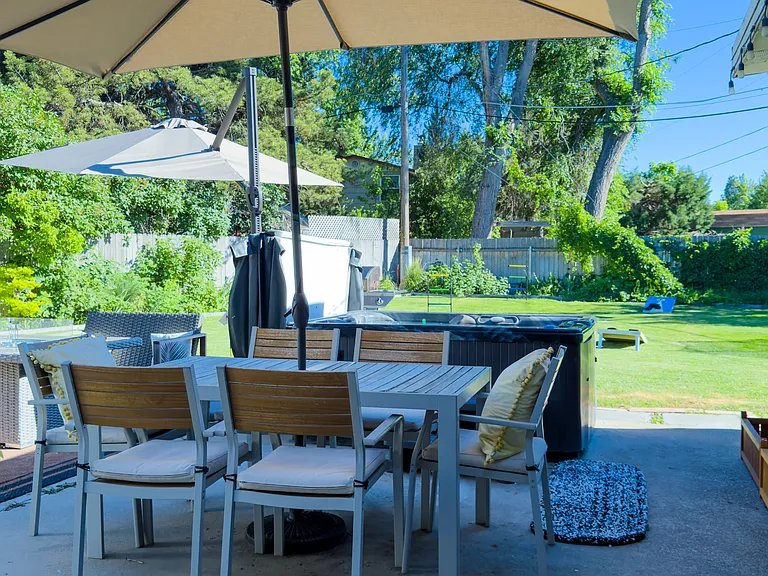 Fully fenced private backyard with hottub/firepit/patio table for 6/trampoline/soccer goal/ mature garden