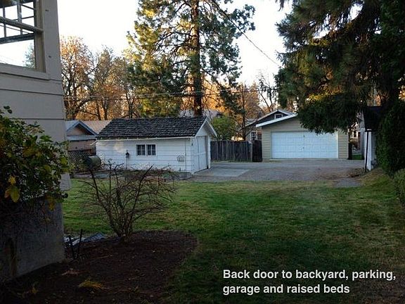 From back door to backyard/alley, parking, garage, raised garden bed and patio.
