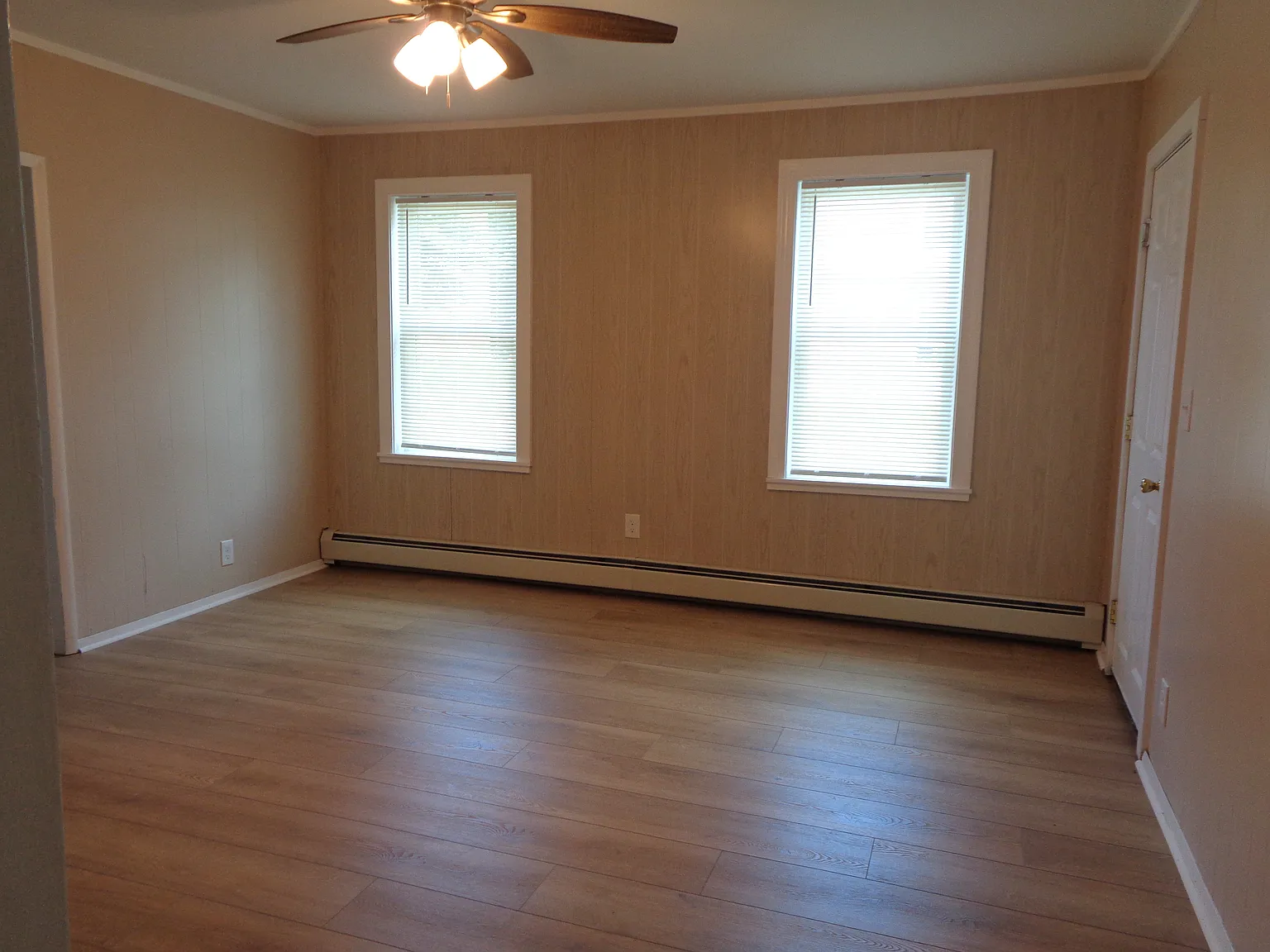 Living Room with New floor, New Windows, New ceiling fan/light, New paint, New Ceiling.