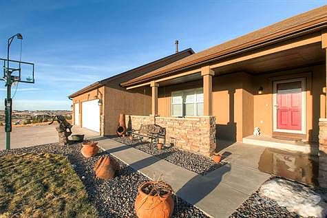 Covered Front Porch with Sitting Area to Enjoy Front Range and Pikes Peak Views