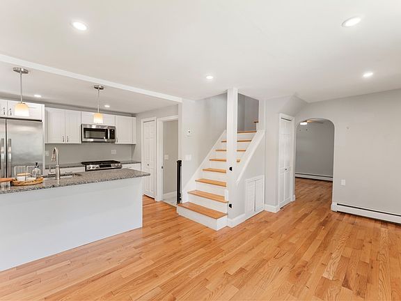 Open-plan main area with den through the arched doorway