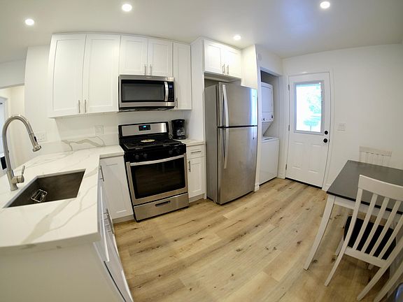 Kitchen - All stainless steel appliances, washer/dryer combo - looking towards back door