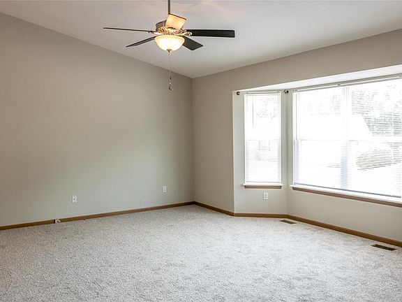 Spacious living room with vaulted ceiling and large bay window