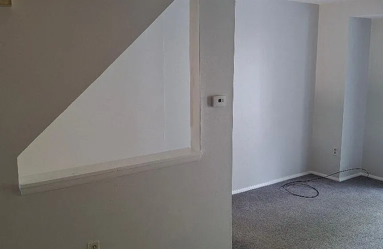 Stairs from garage to First floor Living area, including Kitchen, Powder Room, Dining Room/Living Room combination, 2 closets, and access to private deck.