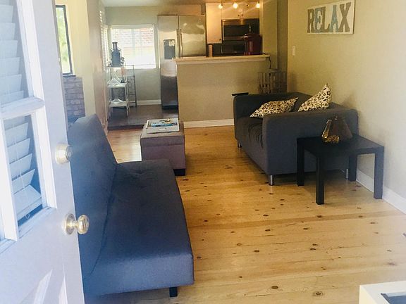 Spacious open concept living area with wood look flooring, u