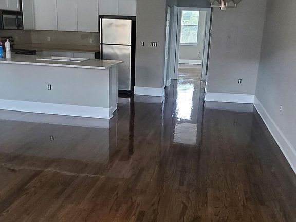 Refinished floors, new paint from top to bottom including the trim, cabinets and new crown molding.