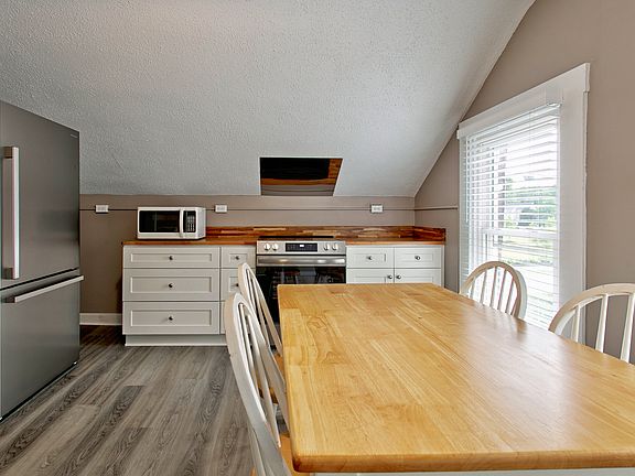 Eat-in kitchen with custom butcher block countertops and brand new appliances.