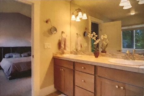 Master bathroom featuring dual vanities, large soaking tub, and walk-in shower