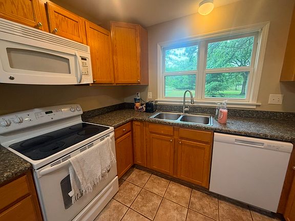 Kitchen with electric stove. Dishwasher included with rental.