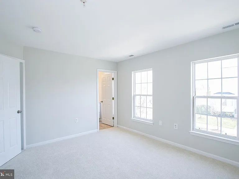 Large, light filled primary bedroom, door to closet and primary bath.