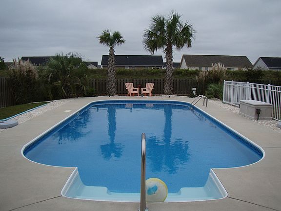 In-ground pool & tropical trees